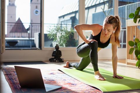 woman-exercising-at-home-in-front-of-her-laptop-royalty-free-image-1586364340.jpg